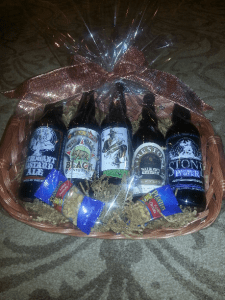 A basket filled with beer and snacks.