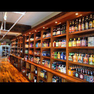 A beer store with shelves full of beer bottles.