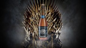 A bottle of Belgian beer sits on top of an iron throne.